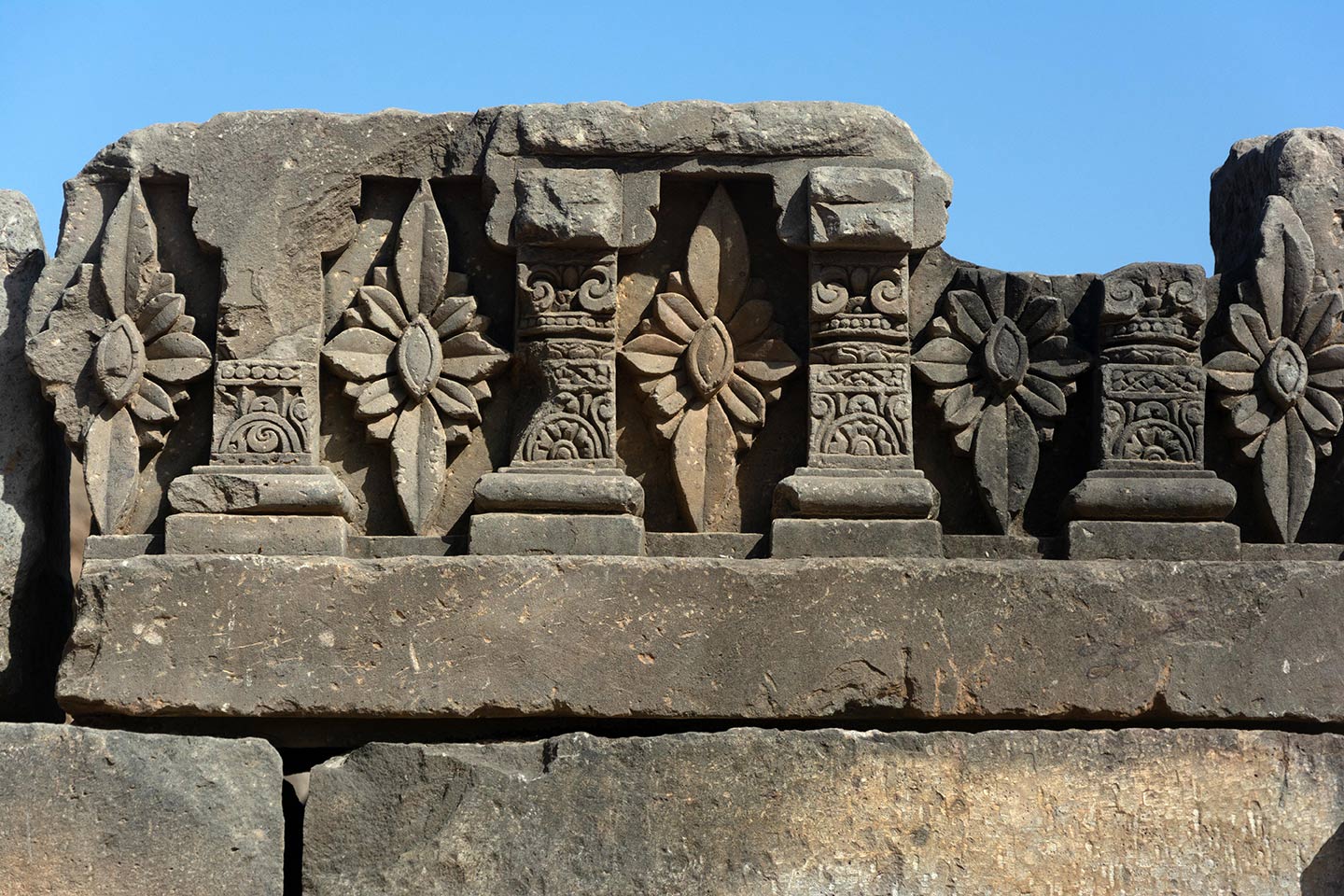 Relief carvings of geometric floriated patterns can be seen all around the adhisthana.