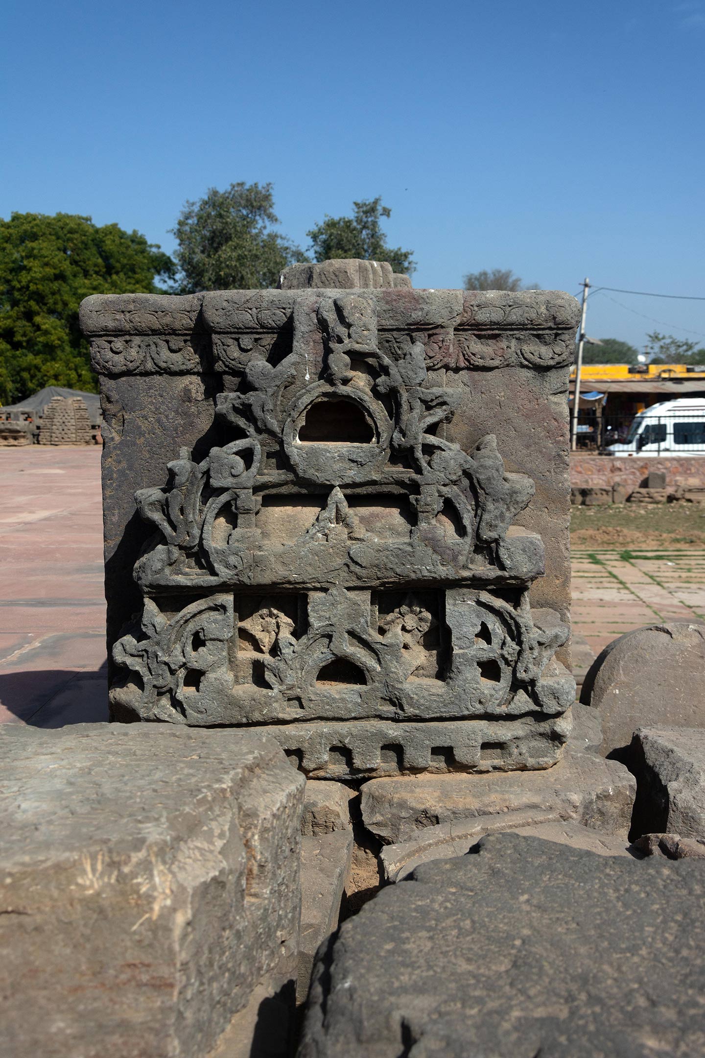 Broken debris from the original temple assembled on the landing of the first set of steps on the adhisthana. The split gavaksha motif is repeated all through the temple. It is a motif that is often seen in Hindu temples.