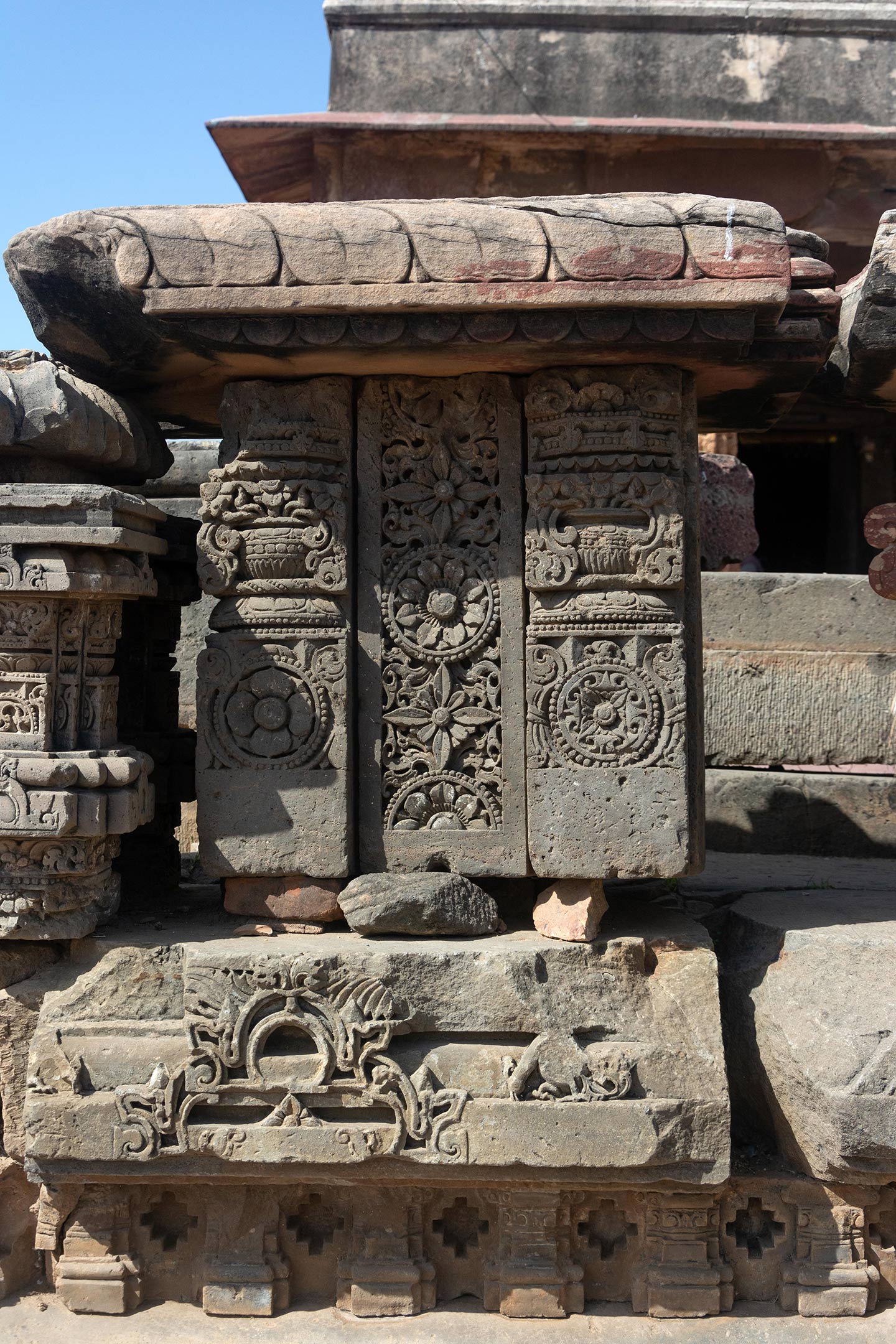 Broken fragments and debris from the original temple assembled on the east face of the adhisthana.