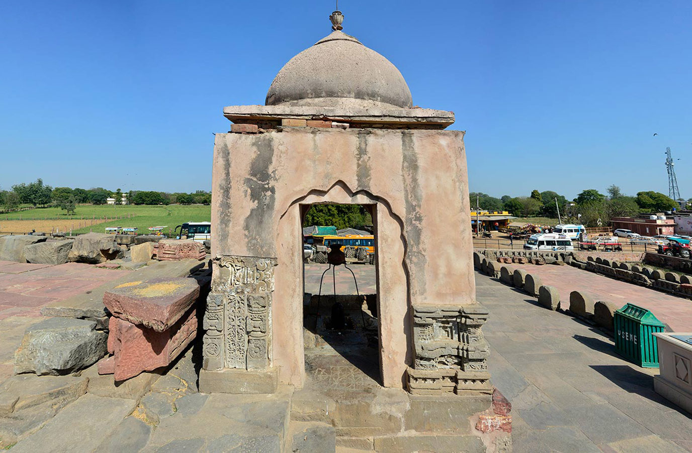 Off-centred to the right, facing the garbhagriha, sits a small shrine, possibly of recent construction. On a projected platform, further steps lead to the third level. The upper part made of concrete is a later addition. The structure has arched openings on the west, east, and north sides, as well as a rectangular entrance inside an arched niche (shown here) on the south side.