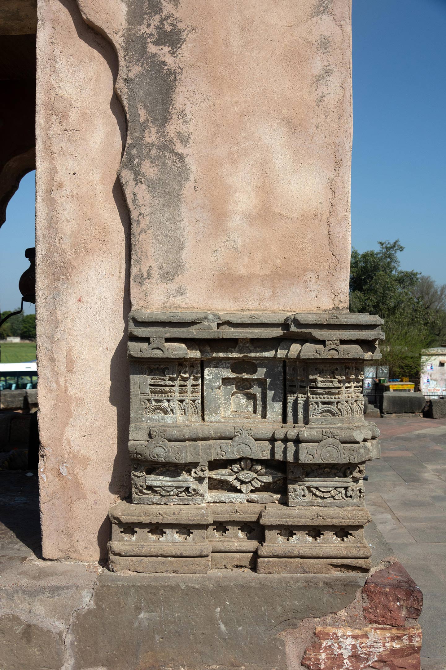 Small shrine, possibly a newer construction, is placed off-centred to the right facing the garbhagriha. On a projected platform, further steps lead to the third level. Pieces from the temple have been repurposed in this shrine. The structure has arched openings on the west, east, and north sides, as well as a rectangular entrance inside an arched niche (shown here) on the south side.