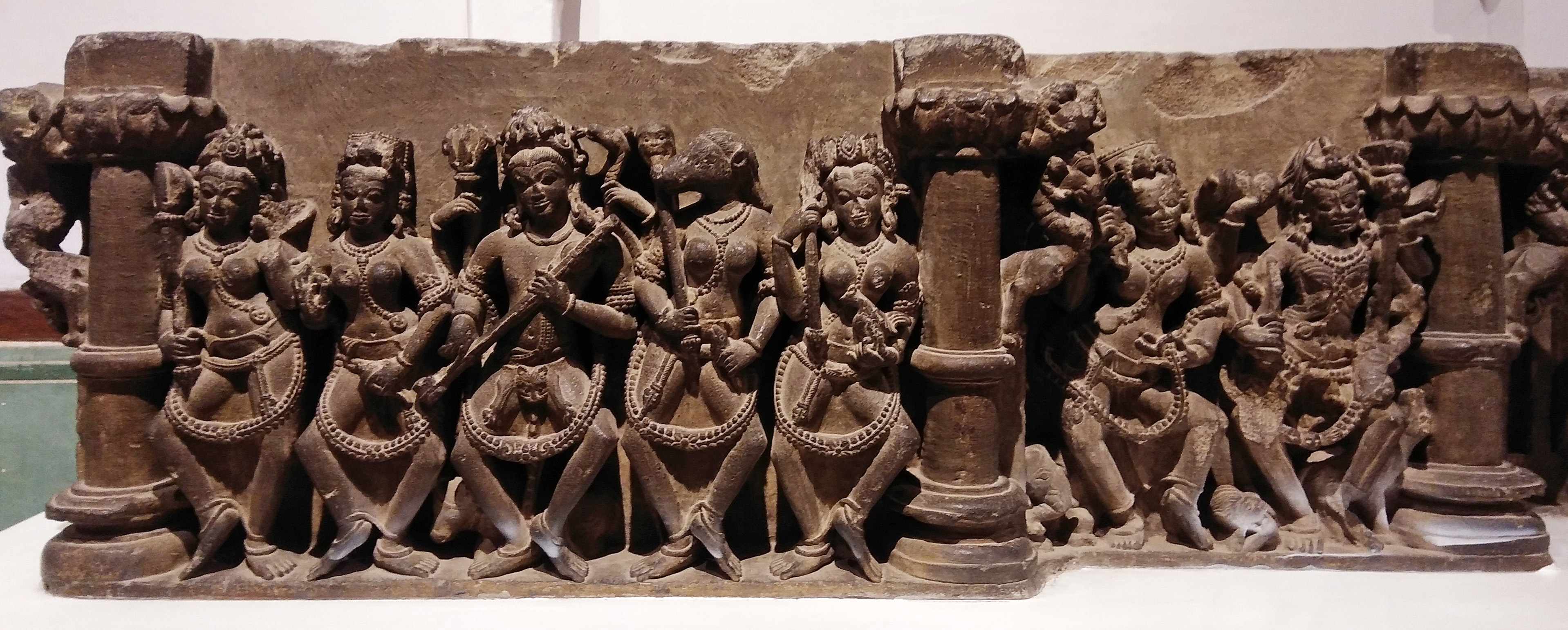 Image 6: The panel divides into two sections, each showcasing the matrikas identified by their vahanas (mounts) in the following order: Maheshvari, Vaishnavi, Vinadhara Shiva, Varahi, and Kaumari. The section on the left features Aindri (or Indrani) and Chamunda.